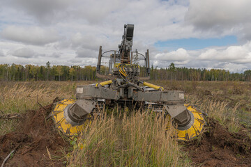 Forest restoration harvester makes furrows for planting spruce pine seedlings. Reforestation on the...