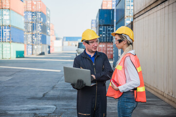 Two foreman man & woman worker working checking at Container cargo harbor holding laptop computer to loading containers. Dock staff business Logistics import export shipping concept.