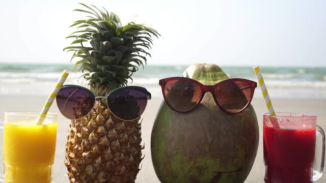 Fruit tourist family pineapple and coconut on a sandy sea beach