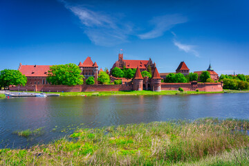 Malbork castle by the Nogat river at summer, Poland