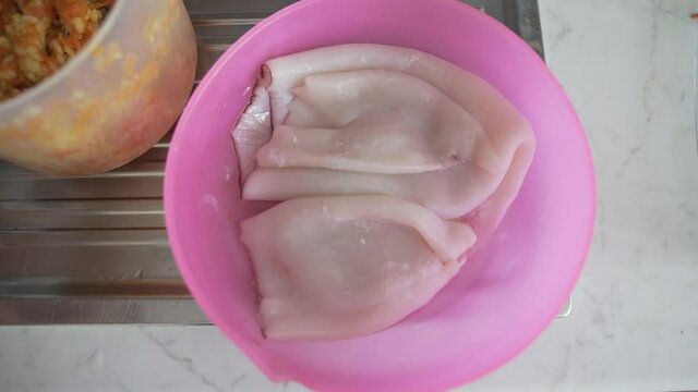 Woman cooks squid for food
