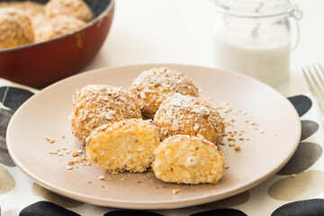 Traditional hungarian cottage cheese balls served with sour cream on a plate.