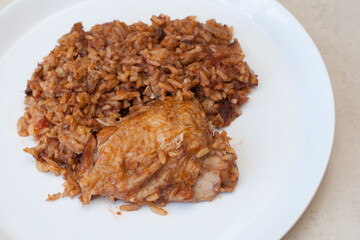 An Iraqi slow cooked chicken and rice dish known as tbiet served on a white dish