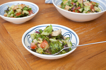 An Arabic Fattoush Salad served in bowls on a dinning room table