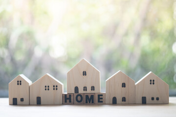 Row of wooden home and put on cube blocks spelling 
