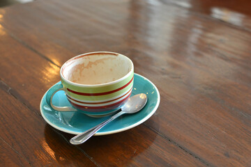 An empty cup of coffee on wooden table / depth of field