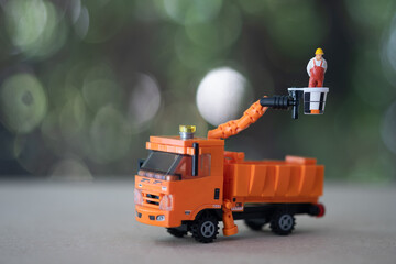 Miniature electrician on picker car crane