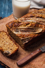 Just baked handmade banana bread, one slice and a glass of milk.