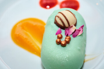 Individual portion of no bake cake sweet dessert. Delicious and beautiful trendy treat for special occasions. Romantic pastry dish. Blue chocolate smooth coating and round shape nicely decorated.