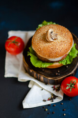 burger with fresh vegetables on a black background