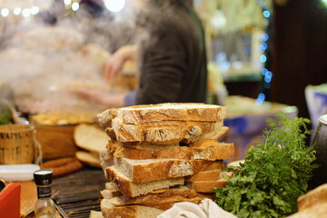 Traditional Polish country bread with lard or garlic butter at a Christmas Market stall in Krakow, Poland. Traditional Polish street food in Cracow.     