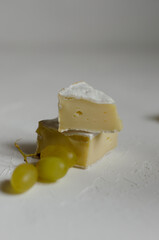 Camembert cheese with red caviar and white wine grapes