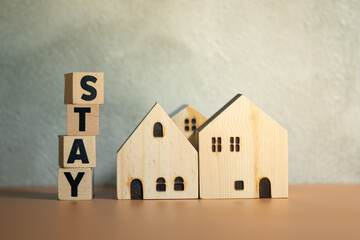 Wooden blocks wording stay and miniature wooden home.