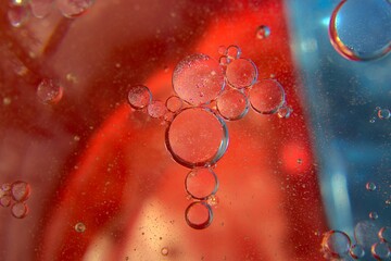 Water bubbles with a red-blue gradient in the background