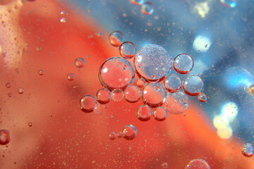 Big and small air bubbles against the red-blue gradient background