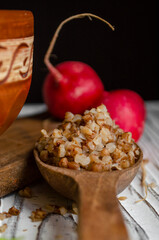 buckwheat porridge in a clay plate with butter and a wooden spoon