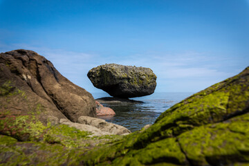 Fototapeta na wymiar Balance Rock, a popular and famous attraction near the village of Skidegate in Haida Gwaii (formerly Queen Charlotte Islands), British Columbia, Canada.