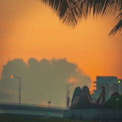 city skyline at sunset couple holding hands