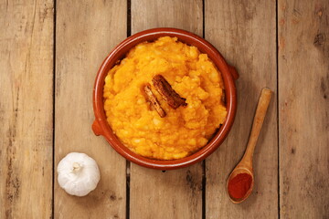Scrambled potatoes with bacon traditional Spanish food overhead view with wooden background