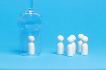 Social distancing conceptual image. White wooden figures of people keep distance on blue background