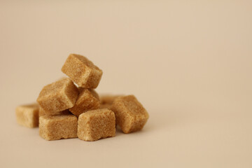 brown cane sugar cubes, light background, selective focus, free copy space