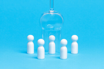 Social distancing conceptual image. White wooden figures of people keep distance on blue background