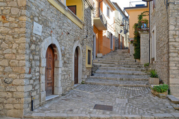Fototapeta na wymiar A narrow street between the old houses of San Marco dei Cavoti, a medieval village in the Campania region.