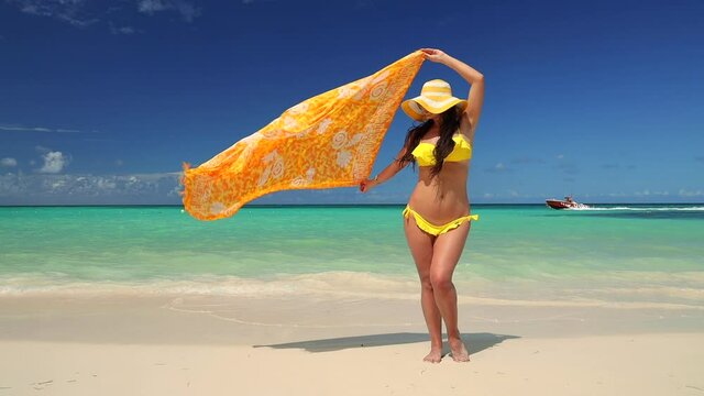 Carefree woman relaxing on exotic beach. Freedom. Caribbean tropical vacation