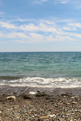 Universal shot of the beach and wave on the sea, blue sky
