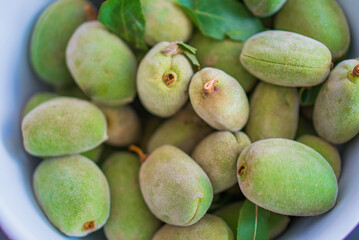 Nuts of green almonds in a skarlup 