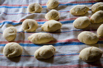 The process of cooking traditional vareniki - textured background. Rural East European cuisine. Dumplings with cottage cheese. Traditional dumplings, pierogi, varenyky