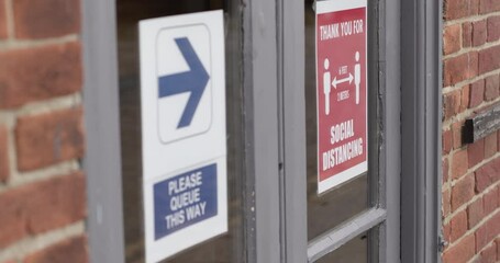 COVID-19 Signage about social distancing on restaurant window during Corona pandemic, Life after lockdown new normal