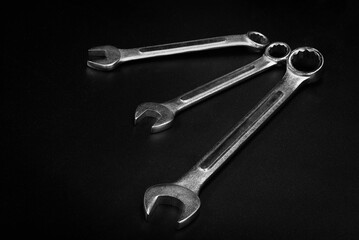Three wrench isolated on black background.