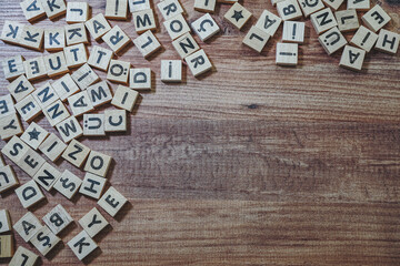 alphabets wooden cubes, wooden background table, view from above.
