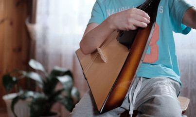 man playing the balalaika. Fingers on the strings