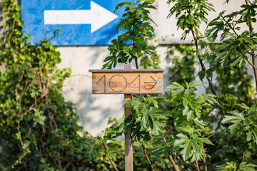 View of wooden board with number 101 and arrow shows direction to home