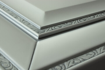 White vintage wooden corner with a frame and an ornament from solid wood with a border and a silver patina in the texture, closeup - ideas for repair, furniture design and just a photo of beautiful wo