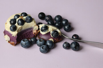 dessert with blueberries on a lilac background close up