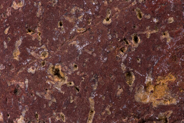 The texture of burgundy stone, close-up. Background.