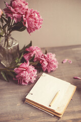 Vintage background, hand made. Pink peony and old scissors, ribbons,  notebook for text. Mothers day.