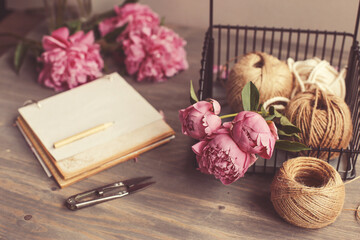 Vintage background, hand made. Pink peony and old scissors, ribbons,  notebook for text. Mothers day.