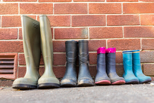 Family Wellington Boots Lined Up After A Walk