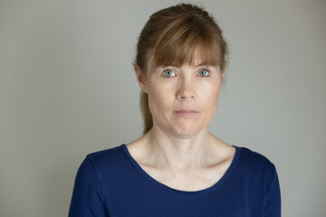 Portrait of unsure middle aged woman