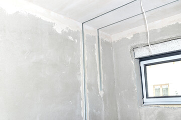 Aluminum profile for LED lighting placed in a wall with cement-lime plaster that goes into the ceiling in a newly built house.
