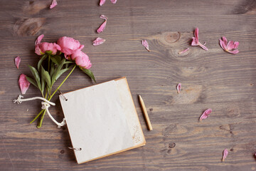 Vintage background, hand made. Pink peony and old scissors, ribbons,  notebook for text. Mothers day.