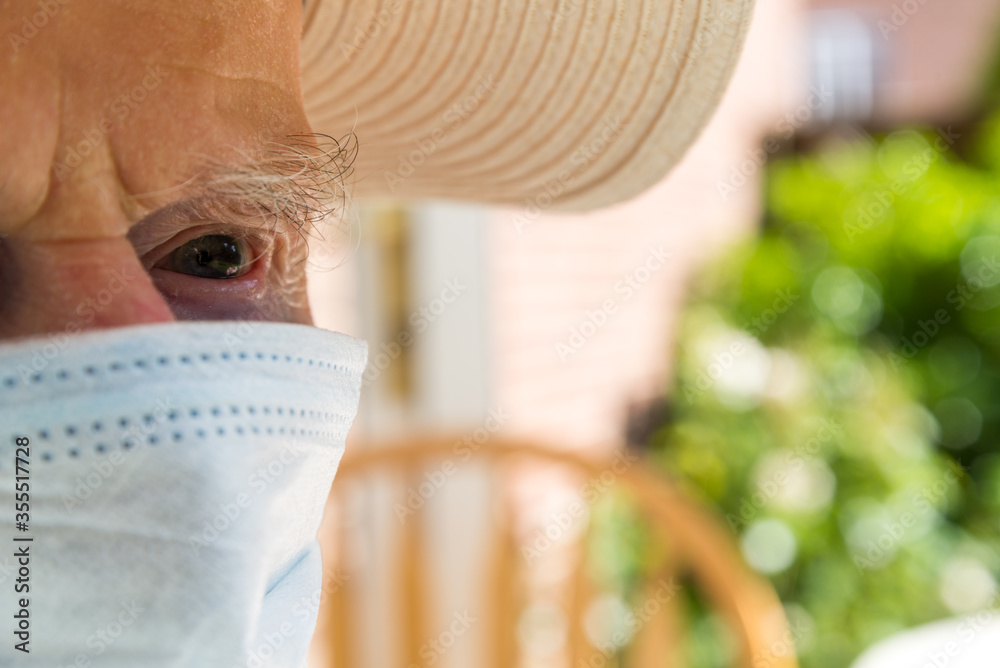 Wall mural Elderly man wearing face mask as Coronavirus protection,Hampshire,United Kingdom.