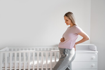 Pregnant woman darts to her pregnant round abdomen in the 9th month of pregnancy, prepares for...