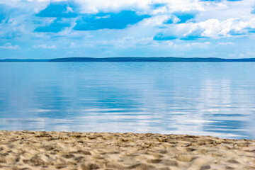 Landscape with sea view, backwater with blue sky and sand of bright color