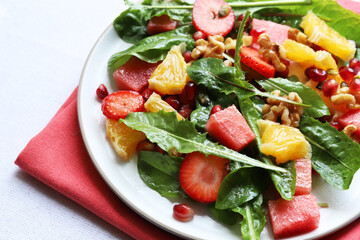 Colourful dandelion salad with fresh fruit.