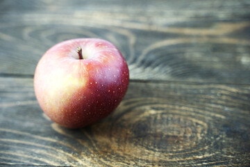 ripe red Apple on a wooden background